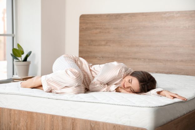 A woman sleeping comfortable on a mattress